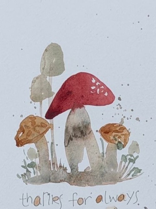 A whimsical watercolor cluster of mushrooms with handwritten pun text and a small heart.